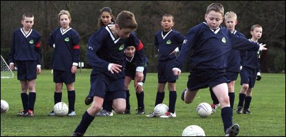 Children Playing Football At School